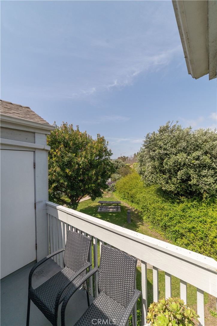 34028 Selva Road, Unit 75 Dana Point, CA 92629 - Photo 28 of 45 a view of a balcony with chair and wooden fence
