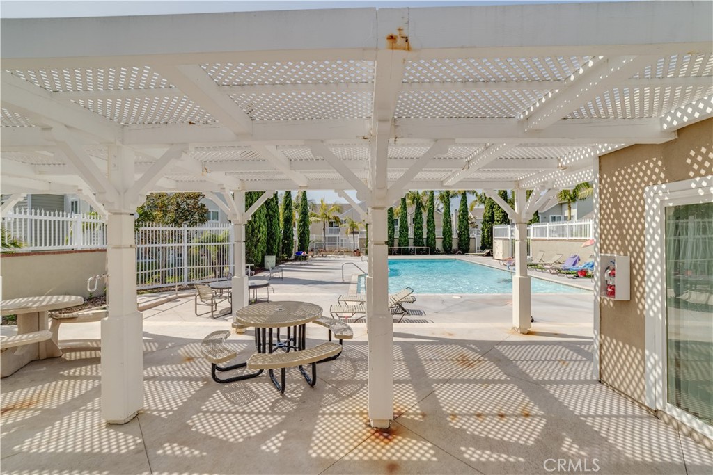 34028 Selva Road, Unit 75 Dana Point, CA 92629 - Photo 32 of 45 a view of a patio with table and chairs potted plants with floor to ceiling window