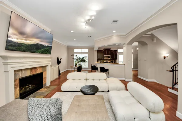 a living room with furniture a flat screen tv and a fireplace