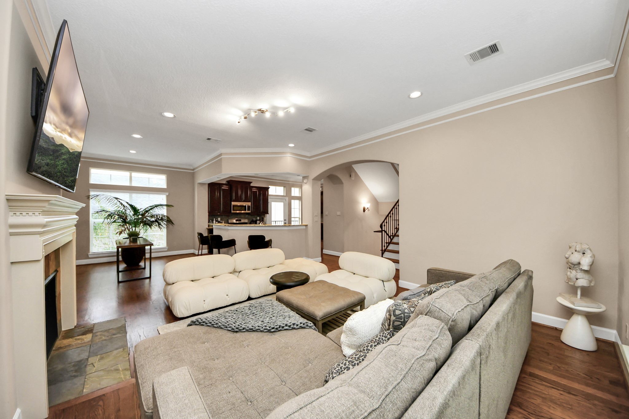 4506 Feagan Street, Unit B Houston, TX 77007 - Photo 11 of 35 a living room with furniture fireplace and a flat screen tv