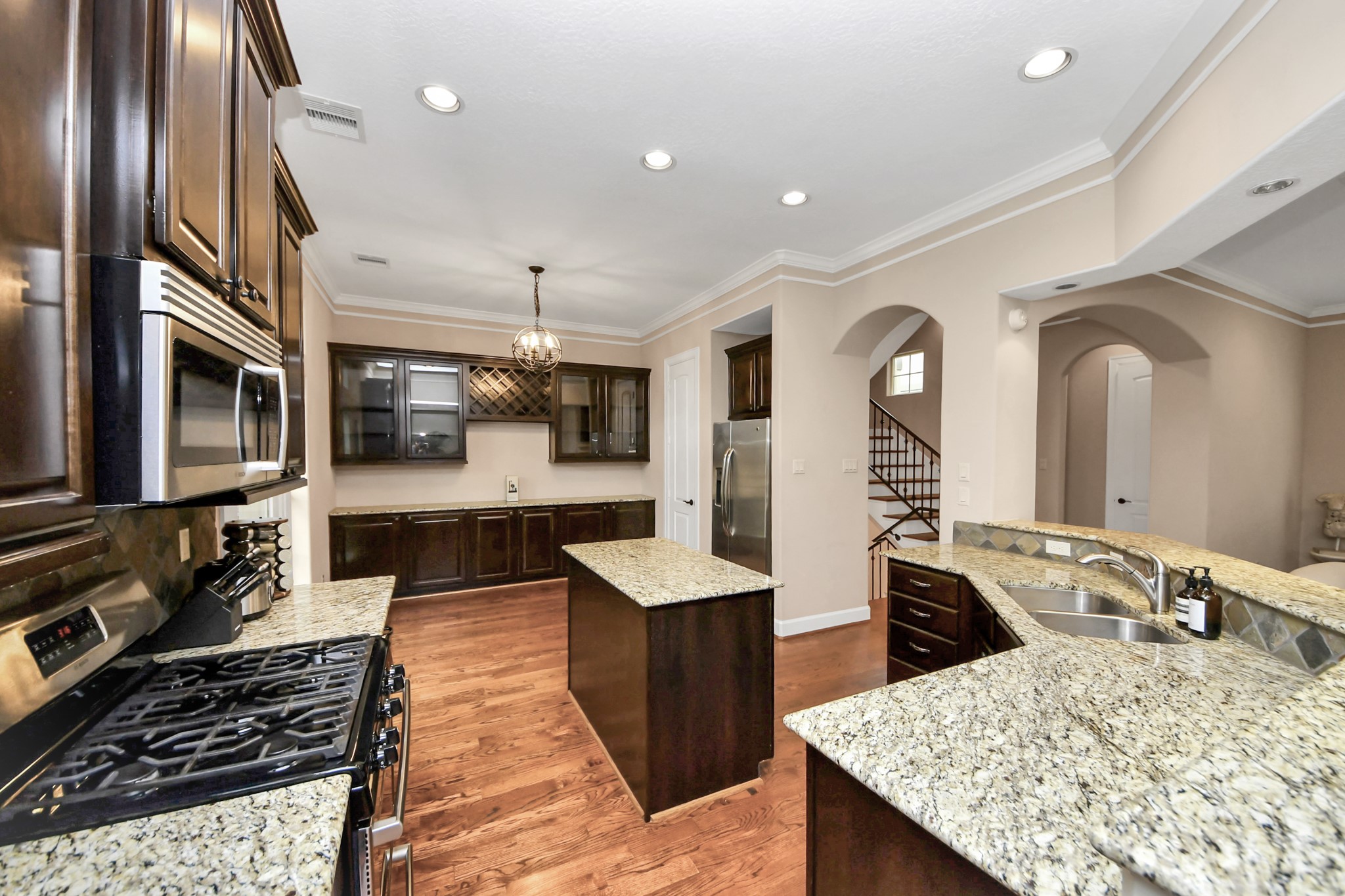 4506 Feagan Street, Unit B Houston, TX 77007 - Photo 15 of 35 a large kitchen with stainless steel appliances granite countertop a lot of counter space and wooden floor