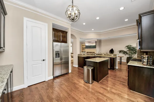a kitchen with stainless steel appliances granite countertop a refrigerator and a stove top oven