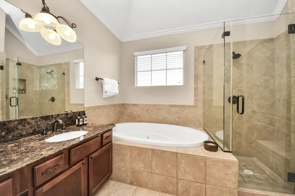 a bathroom with a granite countertop sink a toilet and shower