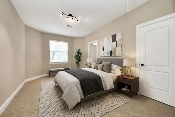 a bedroom with a bed and a window