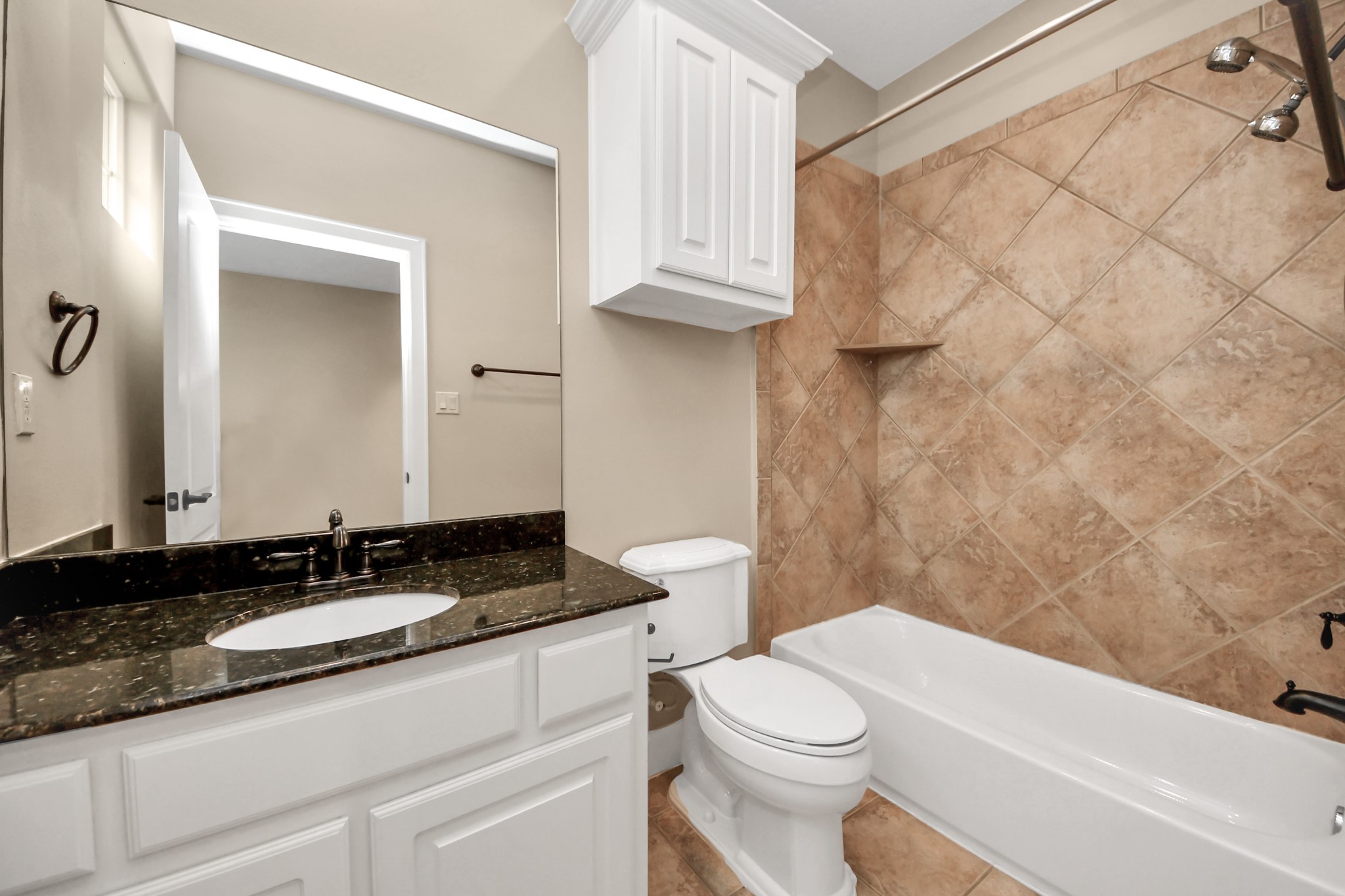 4506 Feagan Street, Unit B Houston, TX 77007 - Photo 31 of 35 a bathroom with a granite countertop sink a toilet and a bathtub