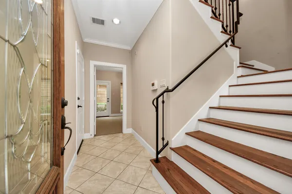 a view of a hallway with wooden floor and staircase