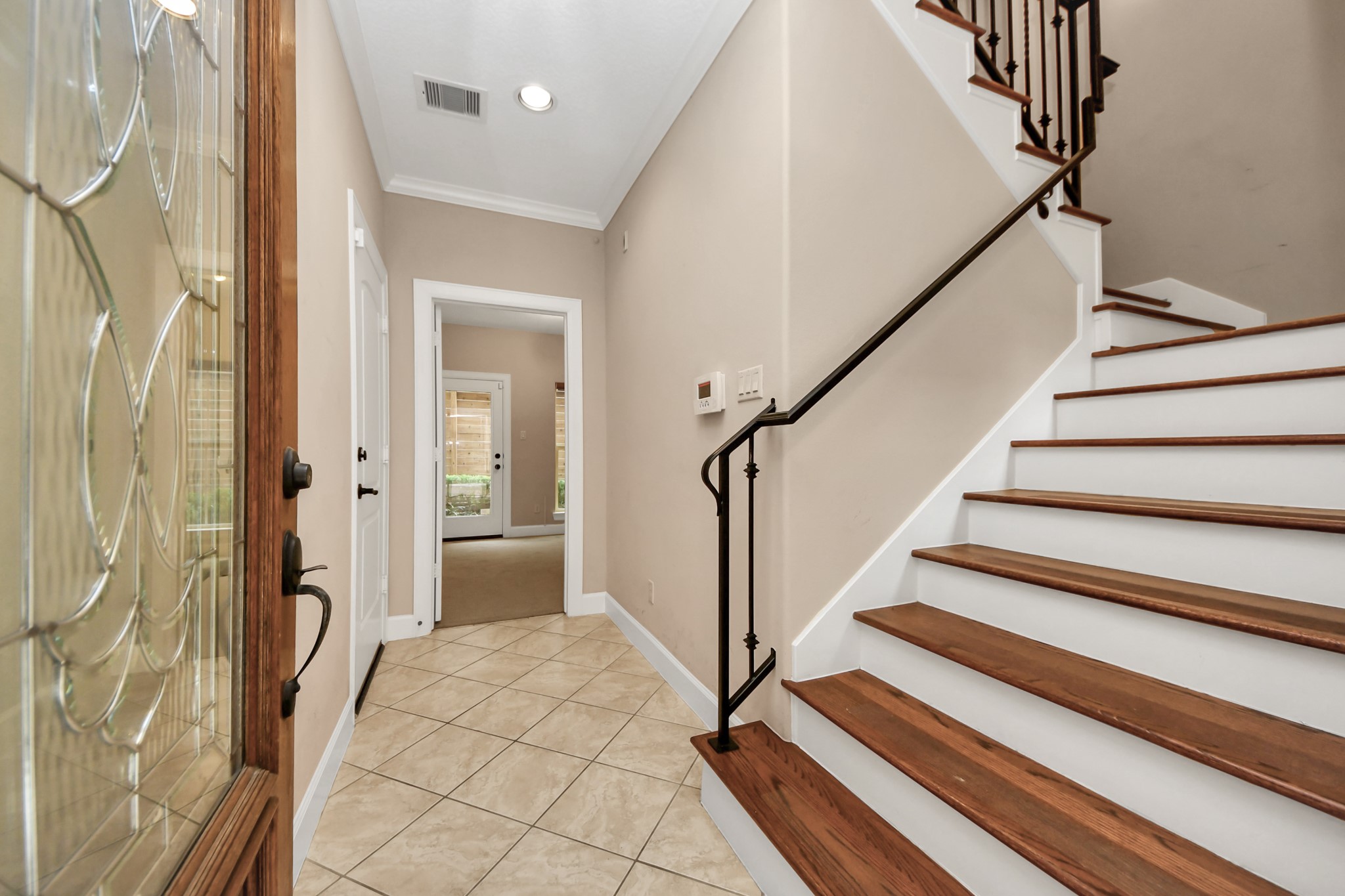4506 Feagan Street, Unit B Houston, TX 77007 - Photo 4 of 35 a view of a hallway with wooden floor and staircase