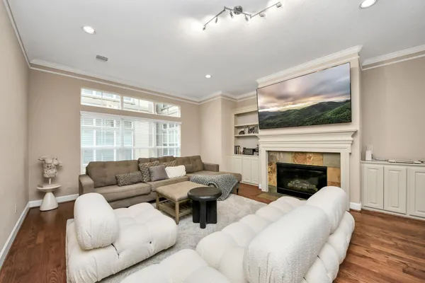 a living room with furniture fireplace and flat screen tv