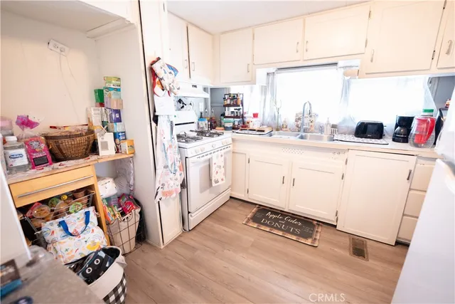 a kitchen with stainless steel appliances a sink and a refrigerator