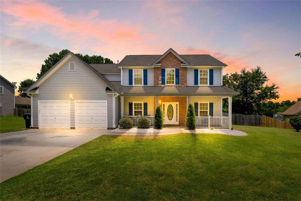a front view of a house with a yard and garage