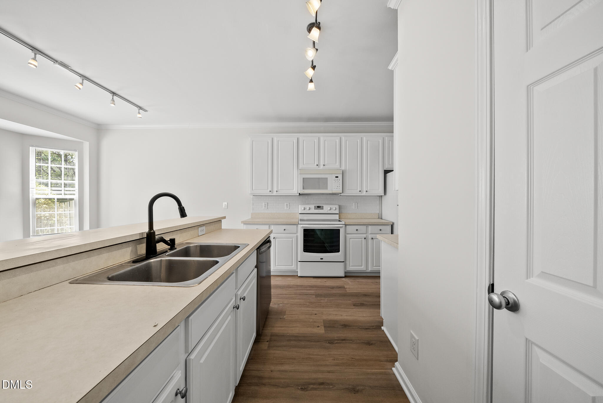1024 Goldmist Lane Durham, NC 27713 - Photo 12 of 46 a kitchen with kitchen island a sink wooden floor and stainless steel appliances