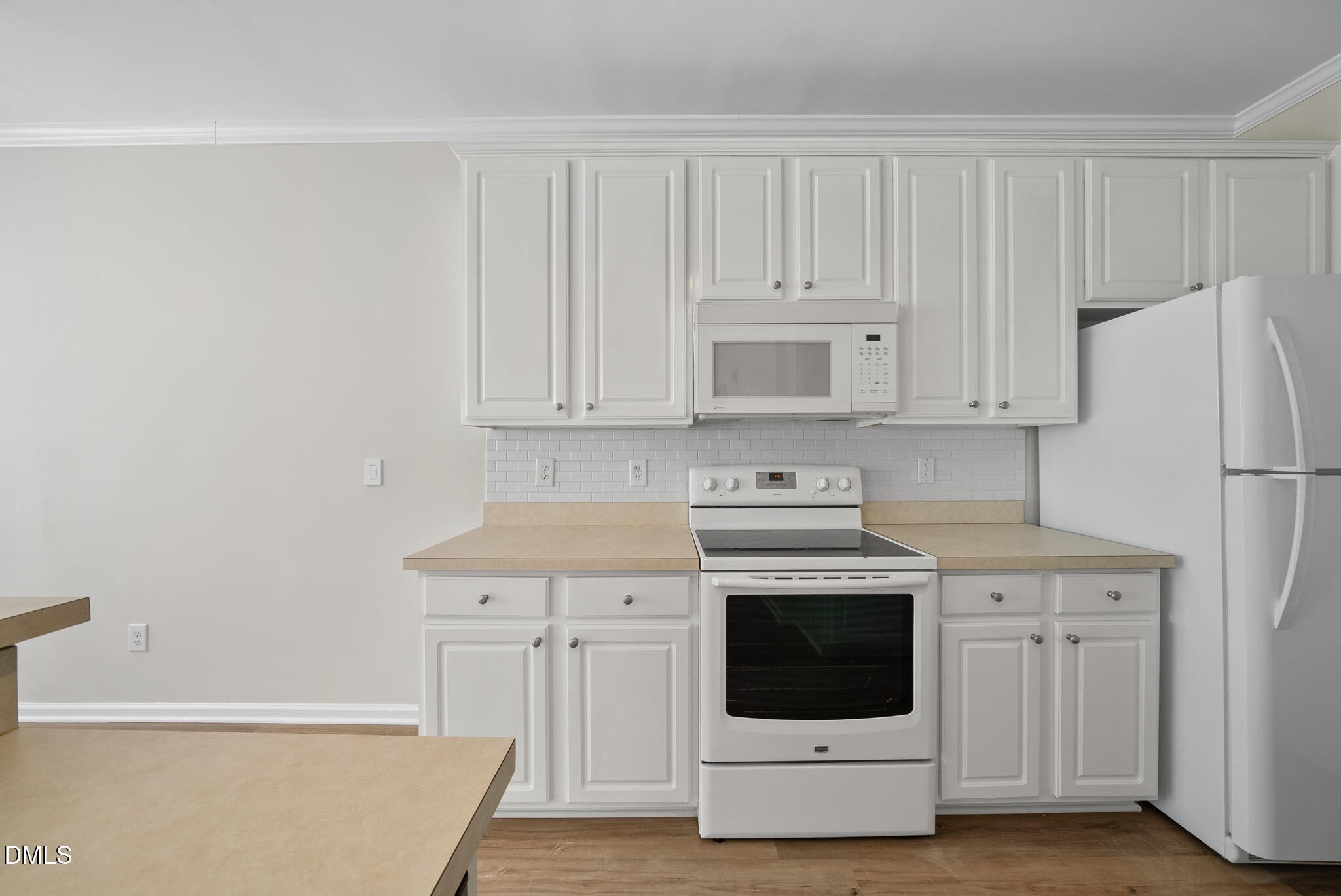 1024 Goldmist Lane Durham, NC 27713 - Photo 14 of 46 a kitchen with a stove top oven and white cabinets
