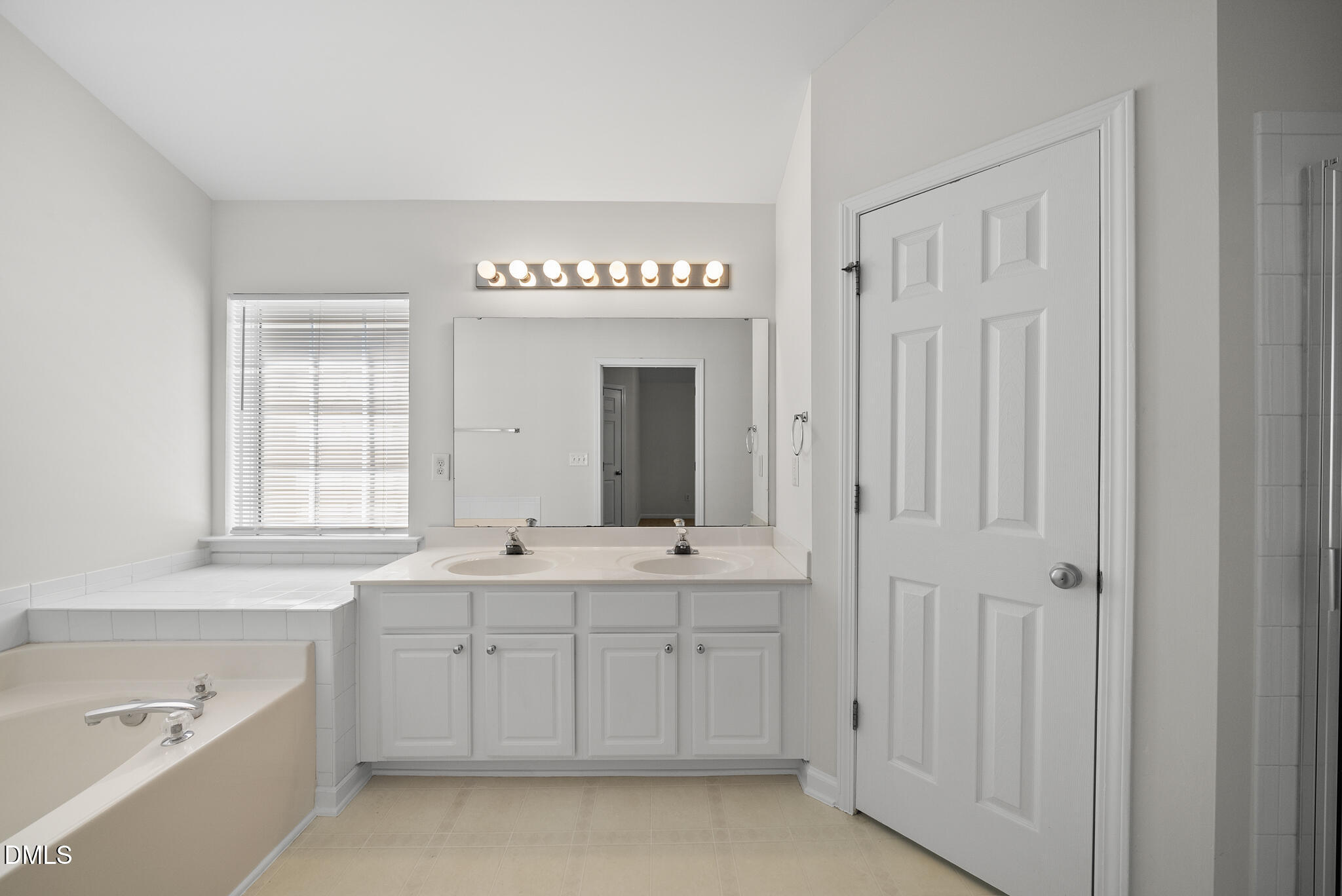 1024 Goldmist Lane Durham, NC 27713 - Photo 20 of 46 a spacious bathroom with a double vanity sink a mirror and a bathtub