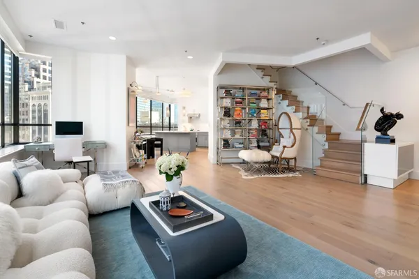 a living room with furniture gym equipment and a wooden floor