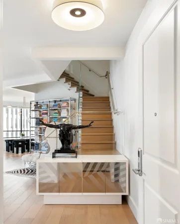 a room with stainless steel appliances lots of furniture and decor