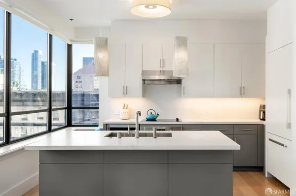 a kitchen with a sink a stove and cabinets