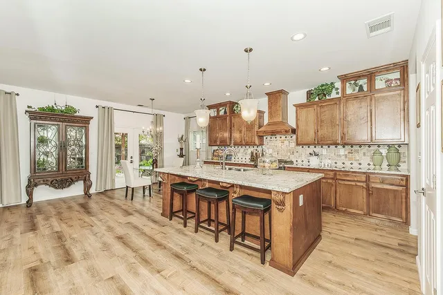 a dining room with furniture a chandelier and wooden floor