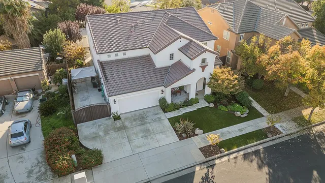 an aerial view of a house with a yard
