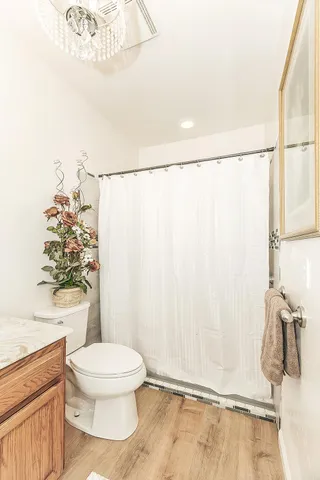 a spacious bedroom with a bed and a chandelier