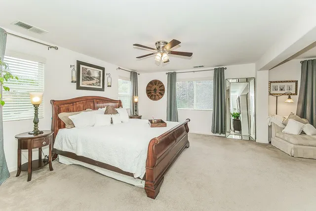 a bedroom with a bed table and a window