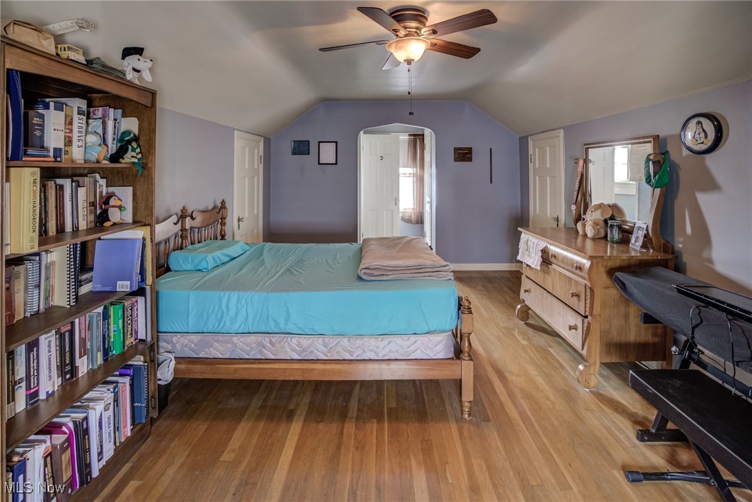 1264 Avondale Road Cleveland, OH 44121 - Photo 17 of 25 Bedroom with lofted ceiling, wood finished floors, arched walkways, and ceiling fan