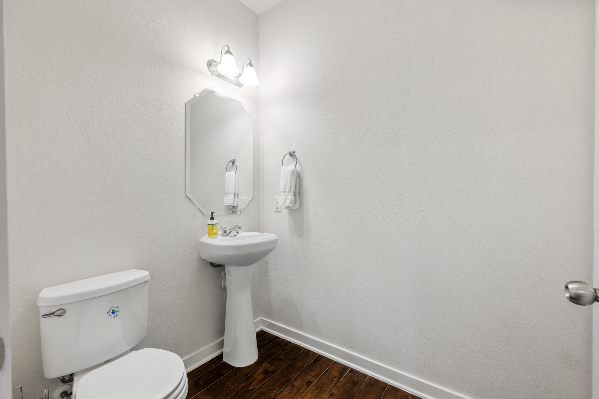 2101 Rivers Edge Way, Unit 19 Austin, TX 78741 - Photo 18 of 24 a bathroom with a sink a toilet and a mirror