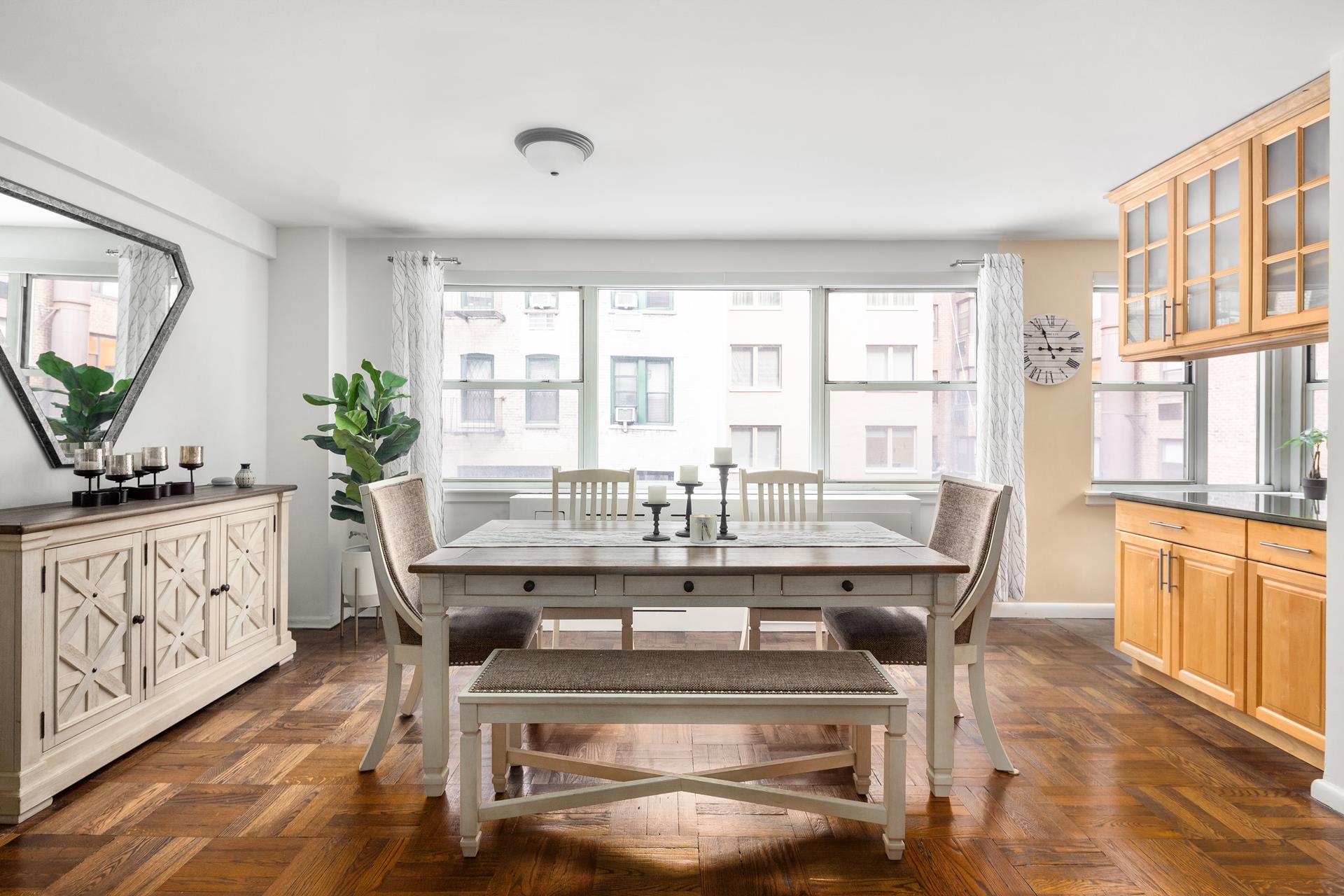 233 East 69th Street, Unit 2A Manhattan, NY 10021 - Photo 3 of 8 a view of a dining room with furniture window and wooden floor