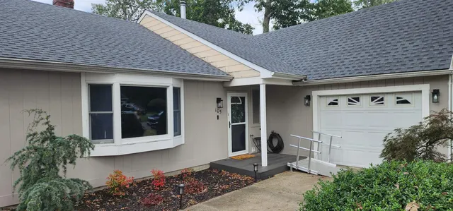 a front view of a house with a garden