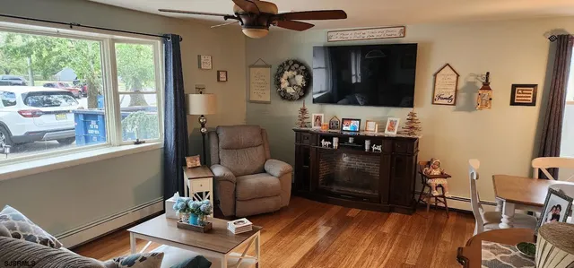 a living room with furniture and wooden floor