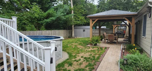 a view of house and patio with wooden fence