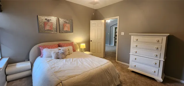 a bedroom with a bed and cabinet