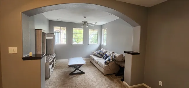 a living room with furniture and a chandelier
