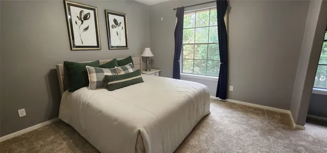 a bedroom with a bed and window