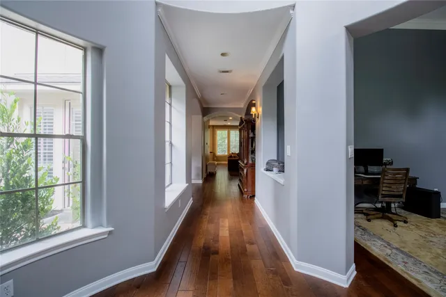 a view of a hallway with wooden floor and staircase