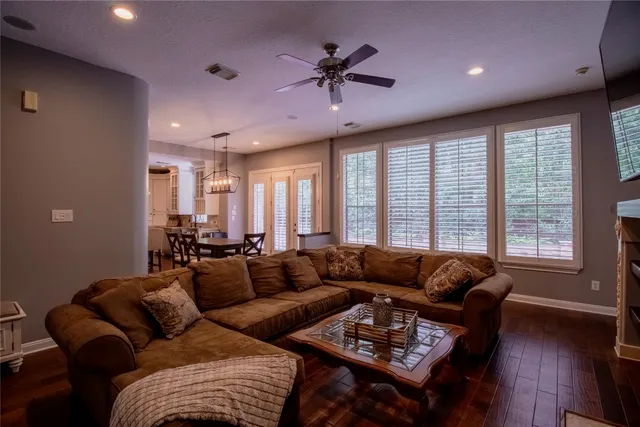 a living room with furniture ceiling fan and a window