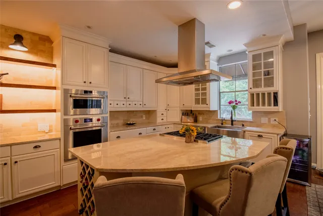 a kitchen with a table chairs microwave and cabinets