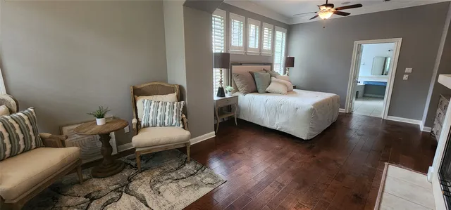 a bedroom with a bed wooden floor and window