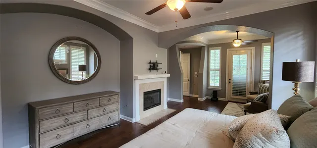 a bedroom with a bed a mirror on the wall and a fireplace