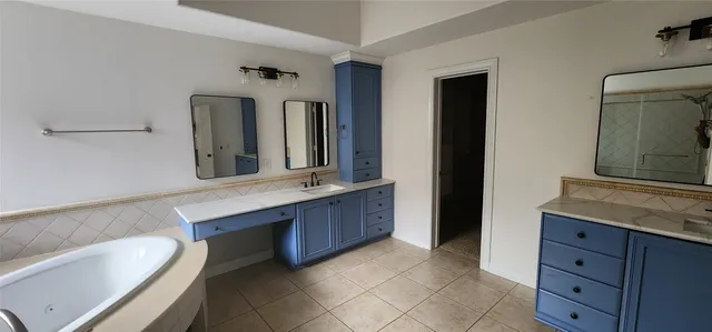 a spacious bathroom with a granite countertop sink and a mirror