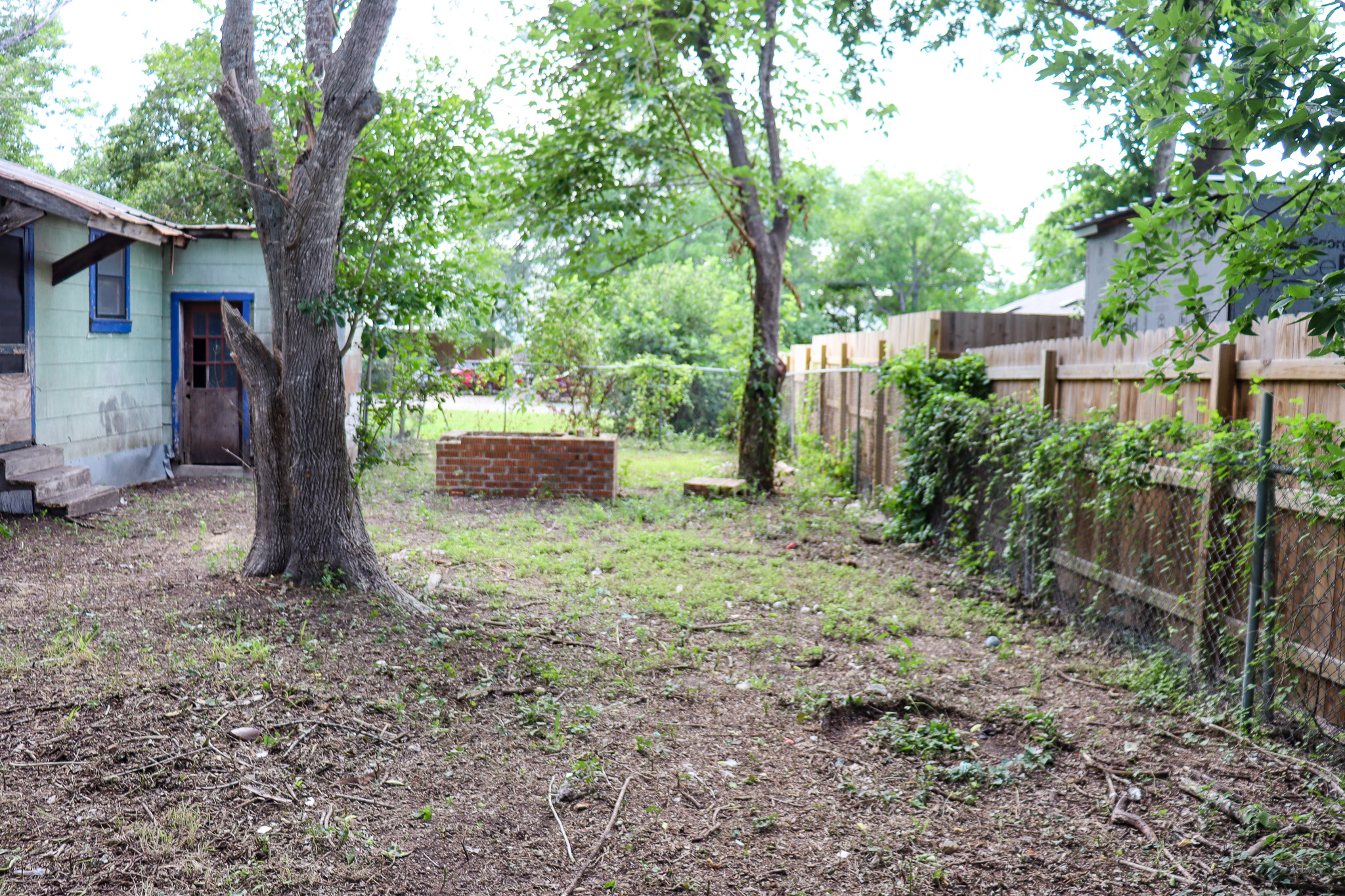 803 3rd Street Lockhart, TX 78644 - Photo 9 of 15 a backyard of a house with lots of green space