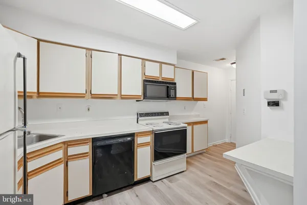 a kitchen with stainless steel appliances granite countertop a stove and a refrigerator
