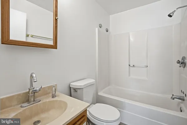 a bathroom with a sink toilet and bathtub