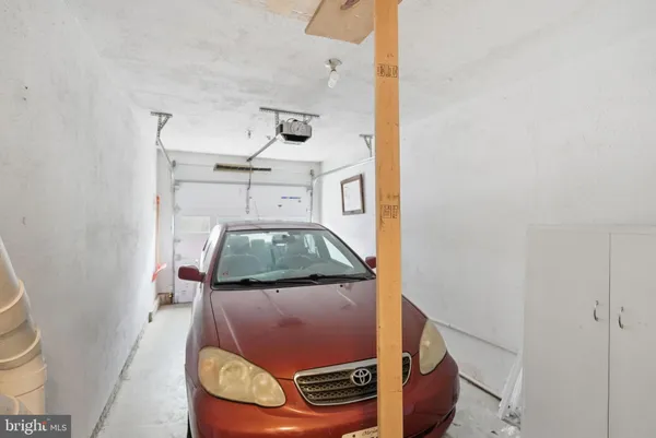 a living room with a couch and a stove with wooden floor
