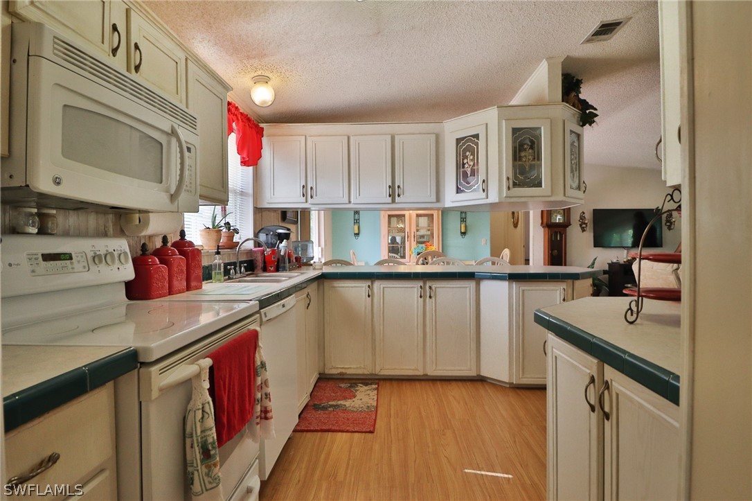 2671 Packinghouse Road Alva, FL 33920 - Photo 16 of 24 a kitchen with stainless steel appliances granite countertop a sink stove and cabinets