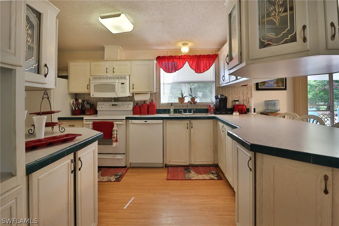 2671 Packinghouse Road Alva, FL 33920 - Photo 17 of 24 a kitchen with a sink cabinets and window