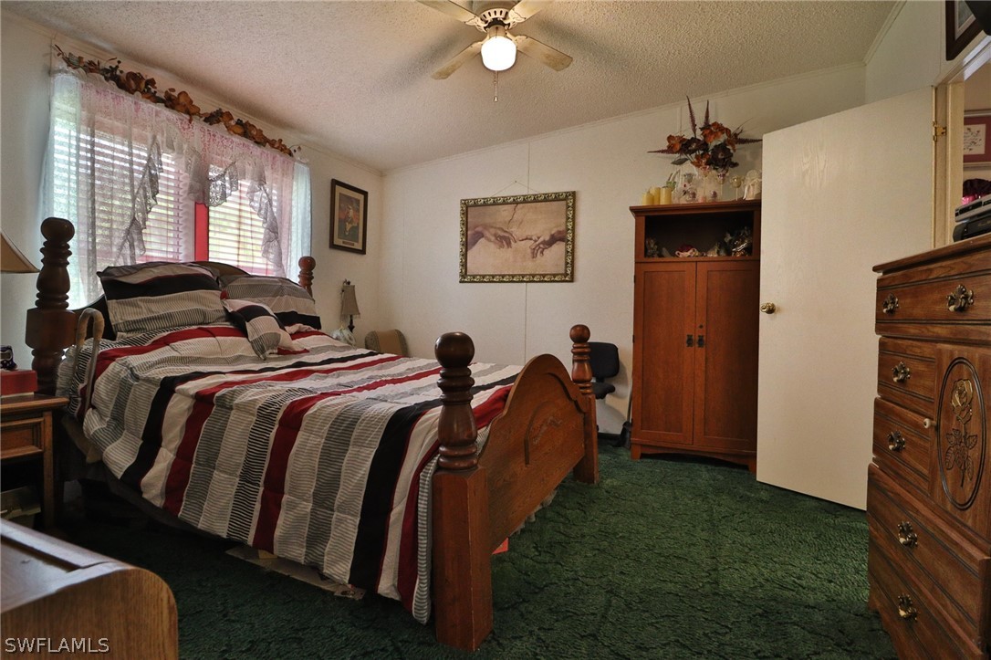 2671 Packinghouse Road Alva, FL 33920 - Photo 19 of 24 a bed room with a bed mirror and a window