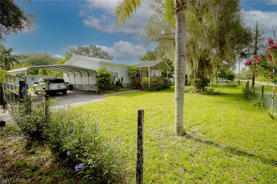 2671 Packinghouse Road Alva, FL 33920 - Photo 3 of 24 a view of a patio with table and chairs under an umbrella