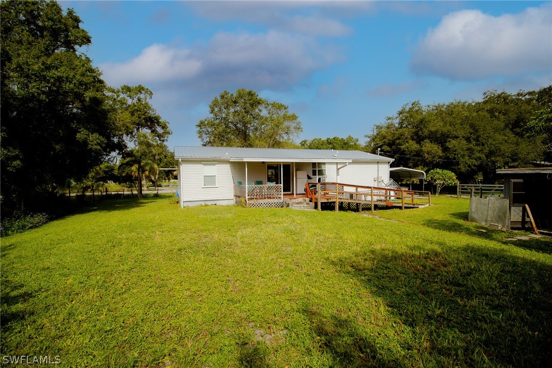 2671 Packinghouse Road Alva, FL 33920 - Photo 4 of 24 a front view of a house with garden