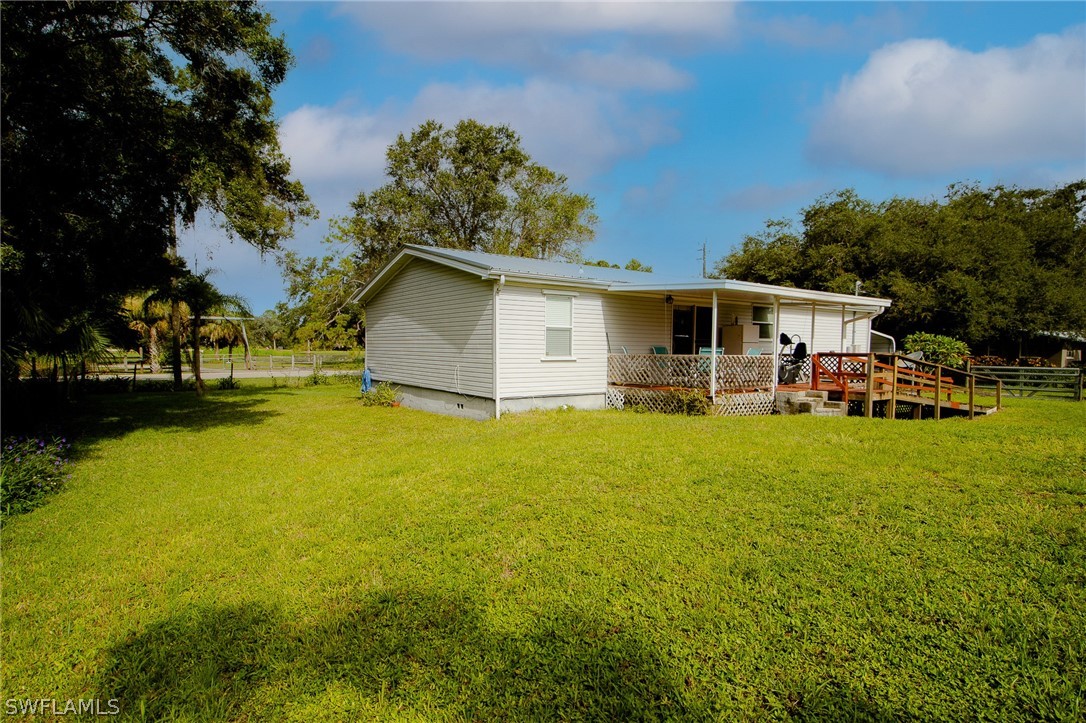 2671 Packinghouse Road Alva, FL 33920 - Photo 5 of 24 a view of a patio with table and chairs under an umbrella