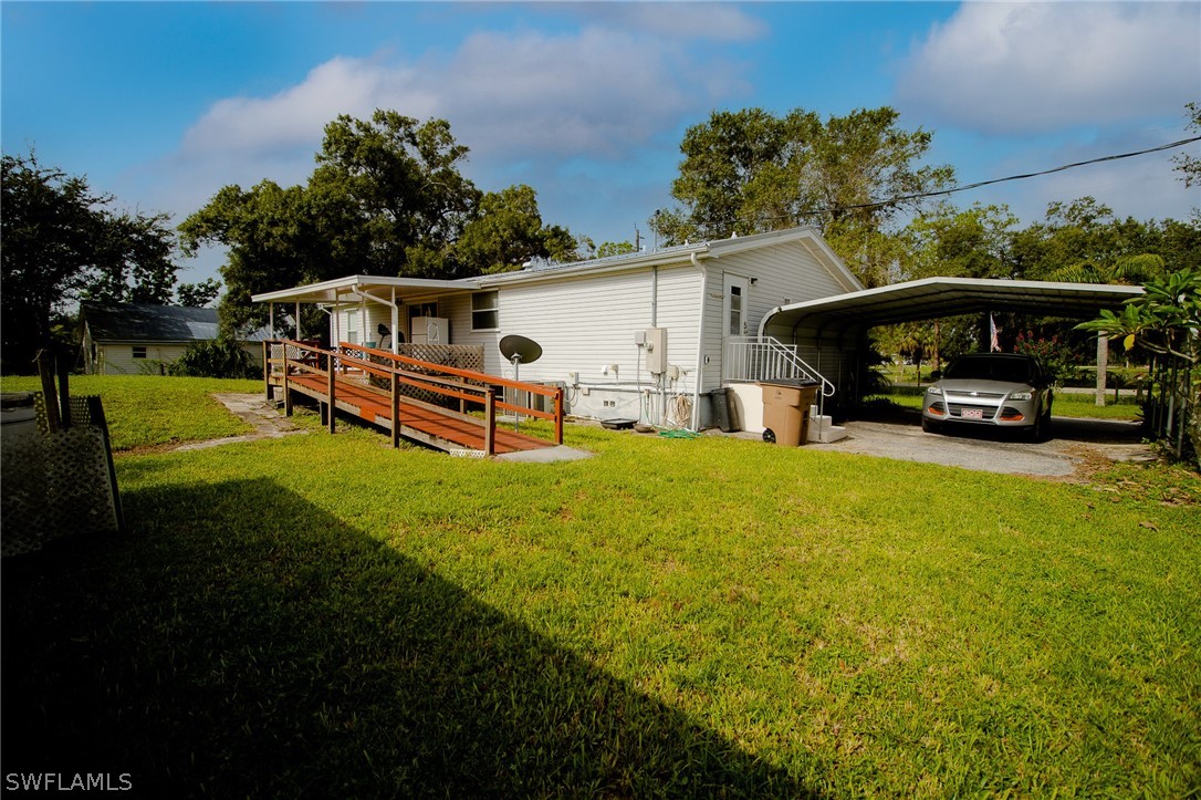 2671 Packinghouse Road Alva, FL 33920 - Photo 6 of 24 a view of a house with backyard and sitting area